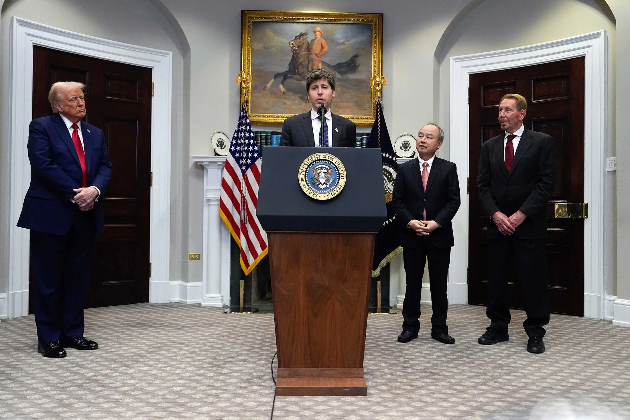 Altman speaking in the White House’s Roosevelt Room with Trump, Son and Ellison.